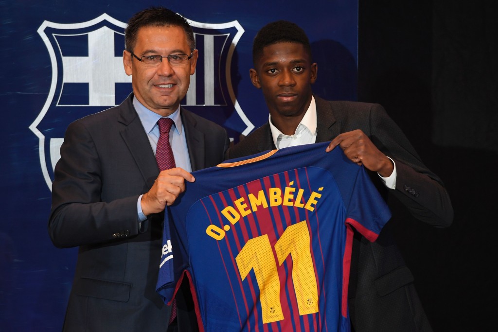 Barcelona's new player Ousmane Dembele (R) poses with his new jersey next to Barcelona's president Josep Maria Bartomeu at the Camp Nou stadium in Barcelona, during his official presentation at the Catalan football club, on August 28, 2017. French starlet Ousmane Dembele agreed a five-year deal with Barcelona worth 105 million euros ($125 million) plus add-ons. Dembele, 20, moves from Borussia Dortmund, where he has been suspended since he boycotted training on August 10 in protest after the German club rejected Barca's first bid. / AFP PHOTO / LLUIS GENE (Photo credit should read LLUIS GENE/AFP/Getty Images)
