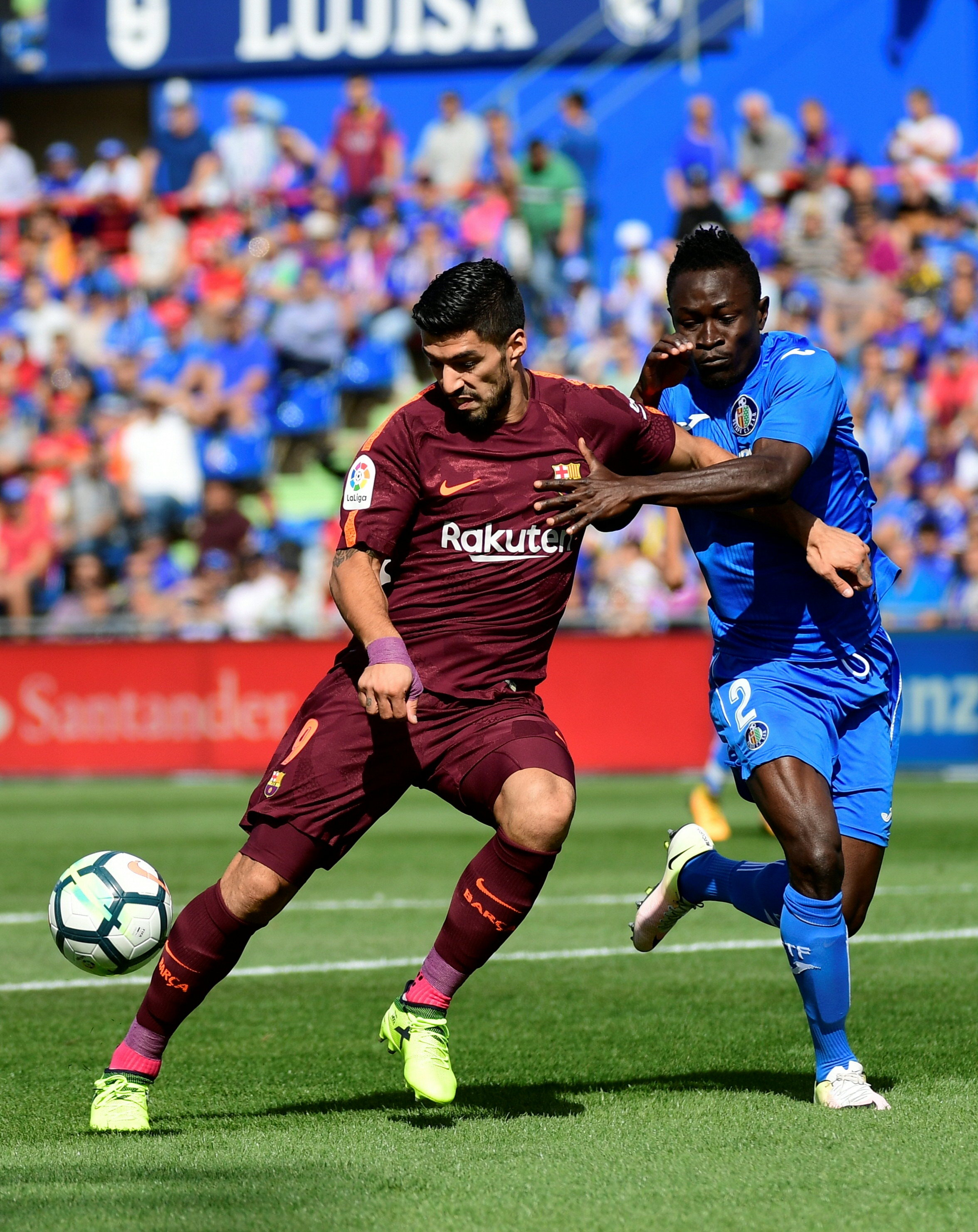 Getafe's defender from Togo Dakonam Djene (R) vies with Barcelona's forward from Uruguay Luis Suarez during the Spanish league football match Getafe CF vs FC Barcelona at the Col. Alfonso Perez stadium in Getafe on September 16, 2017. / AFP PHOTO / PIERRE-PHILIPPE MARCOU (Photo credit should read PIERRE-PHILIPPE MARCOU/AFP/Getty Images)