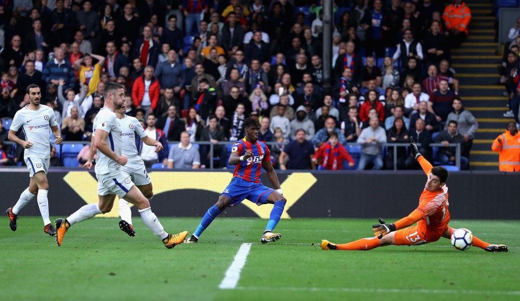 LONDON, ENGLAND - OCTOBER 14: Wilfried Zaha of Crystal Palace scores his sides second goal past Thibaut Courtois of Chelsea during the Premier League match between Crystal Palace and Chelsea at Selhurst Park on October 14, 2017 in London, England. (Photo by Dan Istitene/Getty Images)
