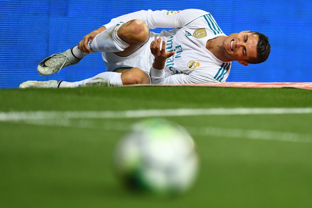 Real Madrid's Portuguese forward Cristiano Ronaldo reacts after being fouled during the Spanish league football match Real Madrid CF vs RCD Espanyol at the Santiago Bernabeu stadium in Madrid on October 1, 2017. / AFP PHOTO / GABRIEL BOUYS (Photo credit should read GABRIEL BOUYS/AFP/Getty Images)