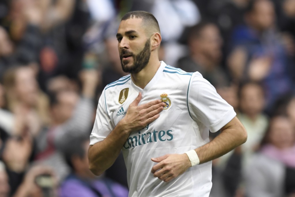 Real Madrid's French forward Karim Benzema celebrates after scoring during the Spanish league football match Real Madrid CF against Malaga CF on 25, November 2017 at the Santiago Bernabeu stadium in Madrid. / AFP PHOTO / GABRIEL BOUYS (Photo credit should read GABRIEL BOUYS/AFP/Getty Images)