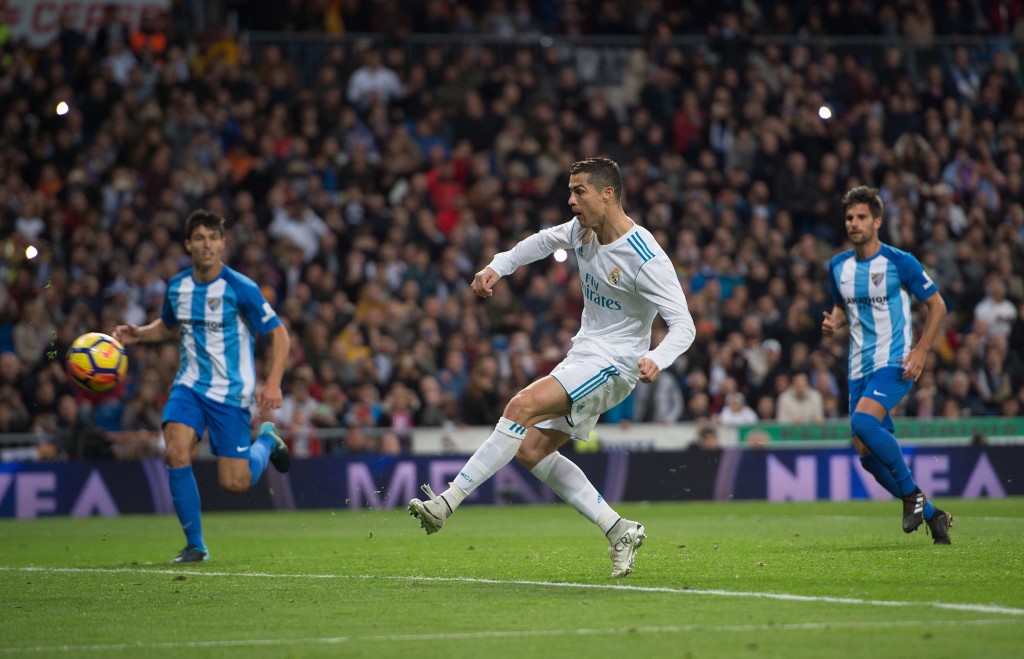 MADRID, SPAIN - NOVEMBER 25: Cristiano Ronaldo of Real Madrid CF scores his team's 3rd goal from a penalty rebound during the La Liga match between Real Madrid and Malaga at Estadio Santiago Bernabeu on November 25, 2017 in Madrid, Spain. (Photo by Denis Doyle/Getty Images)