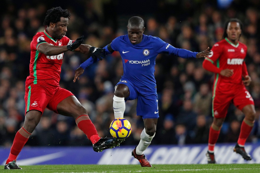 Swansea City's Ivorian striker Wilfried Bony (L) vies with Chelsea's French midfielder N'Golo Kante during the English Premier League football match between Chelsea and Swansea City at Stamford Bridge in London on November 29, 2017. / AFP PHOTO / Adrian DENNIS / RESTRICTED TO EDITORIAL USE. No use with unauthorized audio, video, data, fixture lists, club/league logos or 'live' services. Online in-match use limited to 75 images, no video emulation. No use in betting, games or single club/league/player publications. / (Photo credit should read ADRIAN DENNIS/AFP/Getty Images)