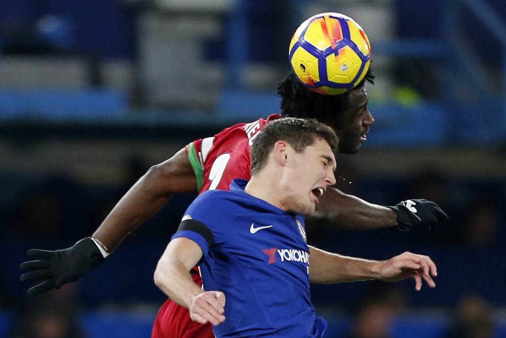 Chelsea's Danish defender Andreas Christensen vies with Swansea City's Ivorian striker Wilfried Bony (R) during the English Premier League football match between Chelsea and Swansea City at Stamford Bridge in London on November 29, 2017. / AFP PHOTO / Ian KINGTON / RESTRICTED TO EDITORIAL USE. No use with unauthorized audio, video, data, fixture lists, club/league logos or 'live' services. Online in-match use limited to 75 images, no video emulation. No use in betting, games or single club/league/player publications. / (Photo credit should read IAN KINGTON/AFP/Getty Images)