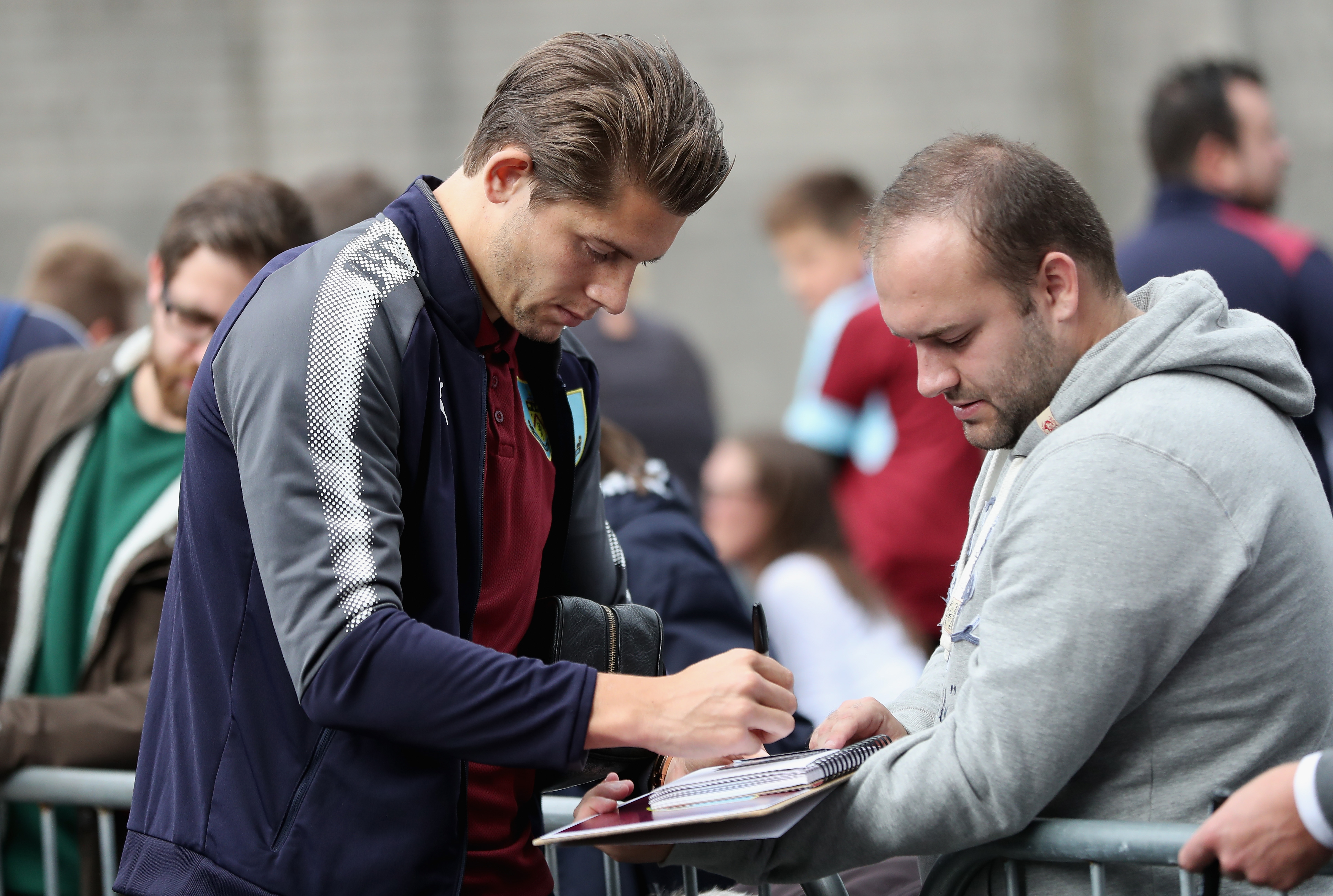 BURNLEY, ENGLAND - SEPTEMBER 23: James Tarkowski of Burnley signs autographs prior to the Premier League match between Burnley and Huddersfield Town at Turf Moor on September 23, 2017 in Burnley, England. (Photo by Ian MacNicol/Getty Images)
