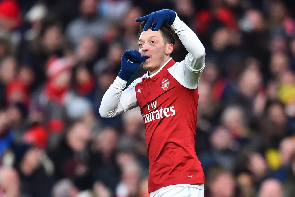 Arsenal's German midfielder Mesut Ozil celebrates after scoring the opening goal of the English Premier League football match between Arsenal and Newcastle United at the Emirates Stadium in London on December 16, 2017. / AFP PHOTO / Glyn KIRK / RESTRICTED TO EDITORIAL USE. No use with unauthorized audio, video, data, fixture lists, club/league logos or 'live' services. Online in-match use limited to 75 images, no video emulation. No use in betting, games or single club/league/player publications. / (Photo credit should read GLYN KIRK/AFP/Getty Images)