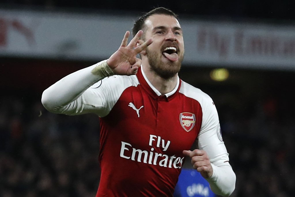 Arsenal's Welsh midfielder Aaron Ramsey (R) celebrates scoring the team's fifth goal during the English Premier League football match between Arsenal and Everton at the Emirates Stadium in London on February 3, 2018. / AFP PHOTO / Adrian DENNIS / RESTRICTED TO EDITORIAL USE. No use with unauthorized audio, video, data, fixture lists, club/league logos or 'live' services. Online in-match use limited to 75 images, no video emulation. No use in betting, games or single club/league/player publications. / (Photo credit should read ADRIAN DENNIS/AFP/Getty Images)