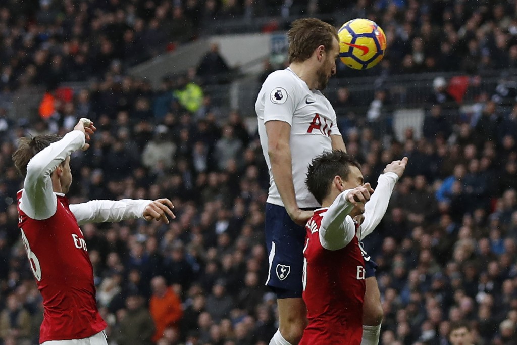 Tottenham Hotspur's English striker Harry Kane (C) heads the ball to score the opening goal during the English Premier League football match between Tottenham Hotspur and Arsenal at Wembley Stadium in London, on February 10, 2018. / AFP PHOTO / Adrian DENNIS / RESTRICTED TO EDITORIAL USE. No use with unauthorized audio, video, data, fixture lists, club/league logos or 'live' services. Online in-match use limited to 75 images, no video emulation. No use in betting, games or single club/league/player publications. / (Photo credit should read ADRIAN DENNIS/AFP/Getty Images)