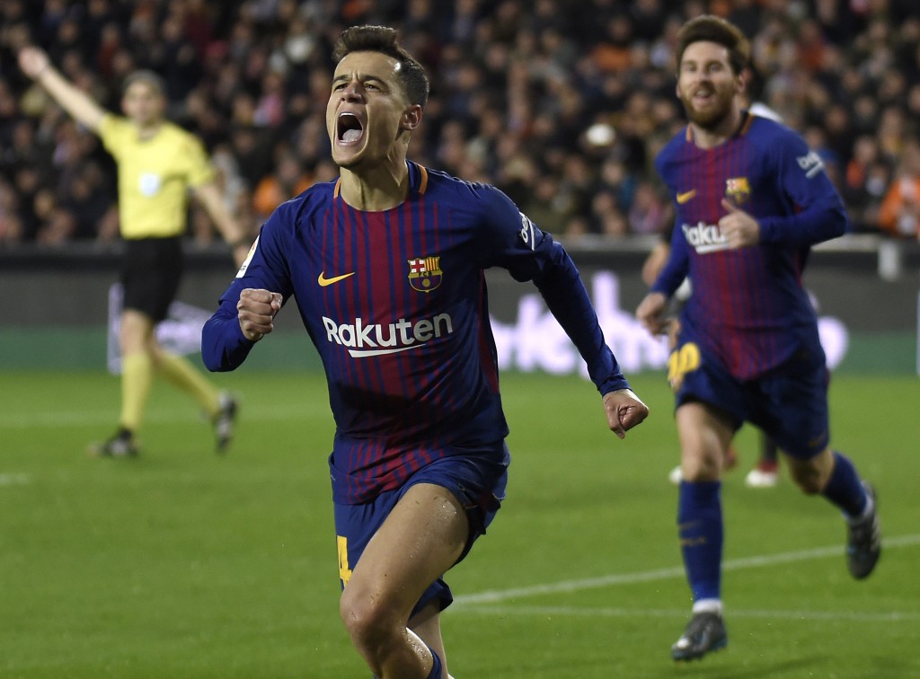 Barcelona's Brazilian midfielder Philippe Coutinho celebrates a goal as Barcelona's Argentinian forward Lionel Messi approaches during the Spanish 'Copa del Rey' (King's cup) second leg semi-final football match between Valencia CF and FC Barcelona at the Mestalla stadium in Valencia on February 8, 2018. / AFP PHOTO / JOSE JORDAN (Photo credit should read JOSE JORDAN/AFP/Getty Images)