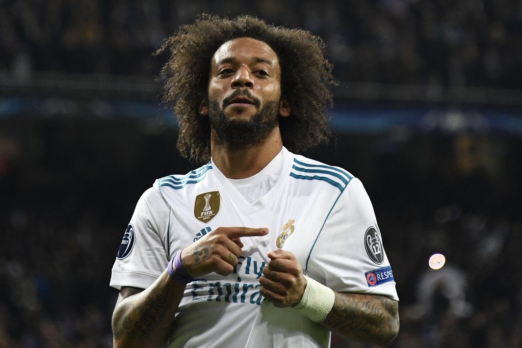 Real Madrid's Brazilian defender Marcelo celebrates after scoring during the UEFA Champions League round of sixteen first leg football match Real Madrid CF against Paris Saint-Germain (PSG) at the Santiago Bernabeu stadium in Madrid on February 14, 2018. / AFP PHOTO / GABRIEL BOUYS (Photo credit should read GABRIEL BOUYS/AFP/Getty Images)