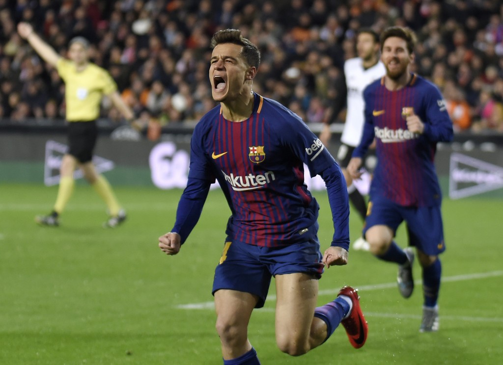 TOPSHOT - Barcelona's Brazilian midfielder Philippe Coutinho celebrates a goal during the Spanish 'Copa del Rey' (King's cup) second leg semi-final football match between Valencia CF and FC Barcelona at the Mestalla stadium in Valencia on February 8, 2018. / AFP PHOTO / JOSE JORDAN (Photo credit should read JOSE JORDAN/AFP/Getty Images)