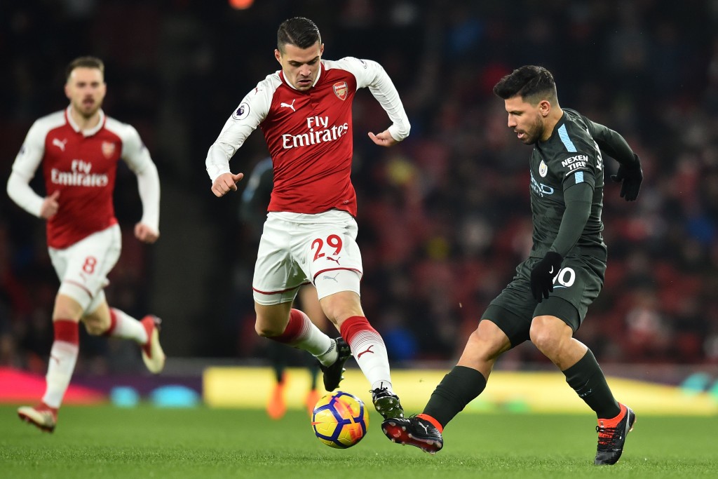 Manchester City's Argentinian striker Sergio Aguero (R) vies with Arsenal's Swiss midfielder Granit Xhaka (C) during the English Premier League football match between Arsenal and Manchester City at the Emirates Stadium in London on March 1, 2018. / AFP PHOTO / Glyn KIRK / RESTRICTED TO EDITORIAL USE. No use with unauthorized audio, video, data, fixture lists, club/league logos or 'live' services. Online in-match use limited to 75 images, no video emulation. No use in betting, games or single club/league/player publications. / (Photo credit should read GLYN KIRK/AFP/Getty Images)