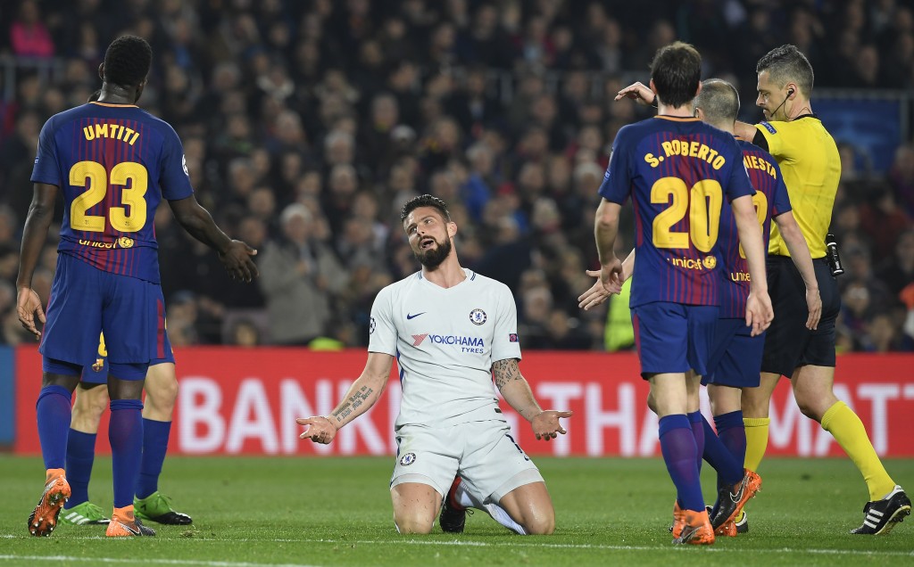 Chelsea's French attacker Olivier Giroud (C) talks to Barcelona's French defender Samuel Umtiti (L) during the UEFA Champions League round of sixteen second leg football match between FC Barcelona and Chelsea FC at the Camp Nou stadium in Barcelona on March 14, 2018. / AFP PHOTO / LLUIS GENE (Photo credit should read LLUIS GENE/AFP/Getty Images)