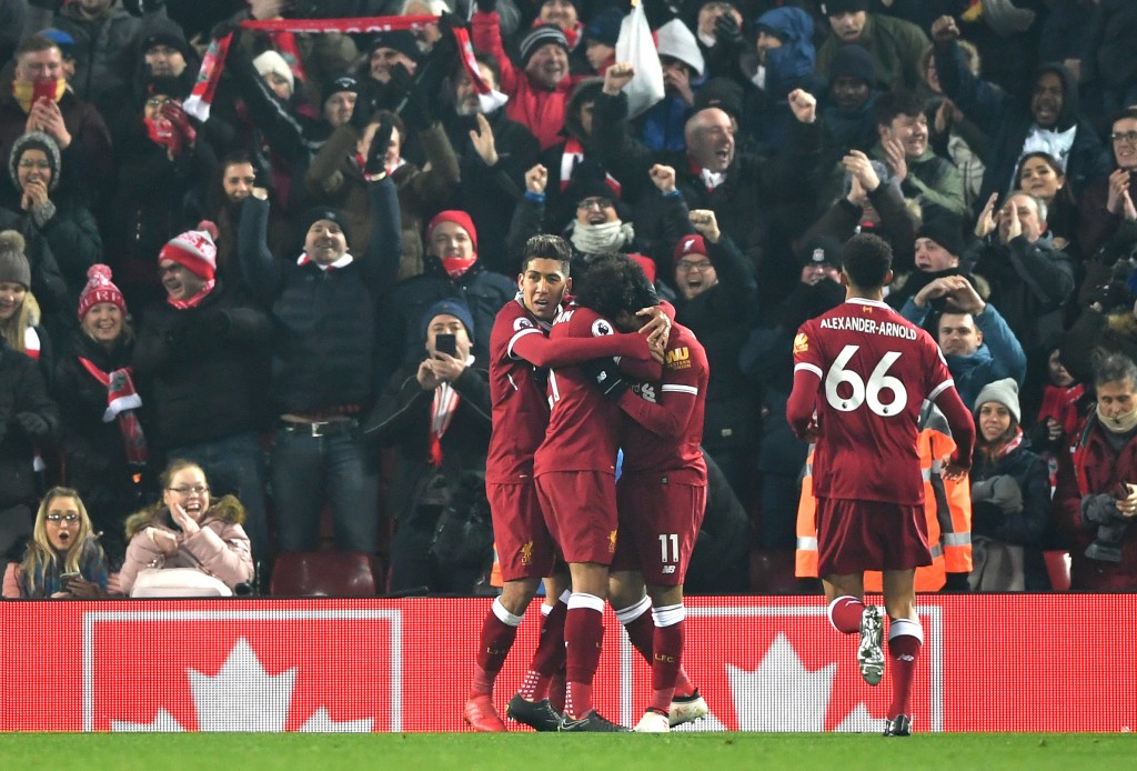 LIVERPOOL, ENGLAND - MARCH 03; Mohamed Salah of Liverpool celebrates with team mates after scoring his sides first goal during the Premier League match between Liverpool and Newcastle United at Anfield on March 3, 2018 in Liverpool, England. (Photo by Gareth Copley/Getty Images)