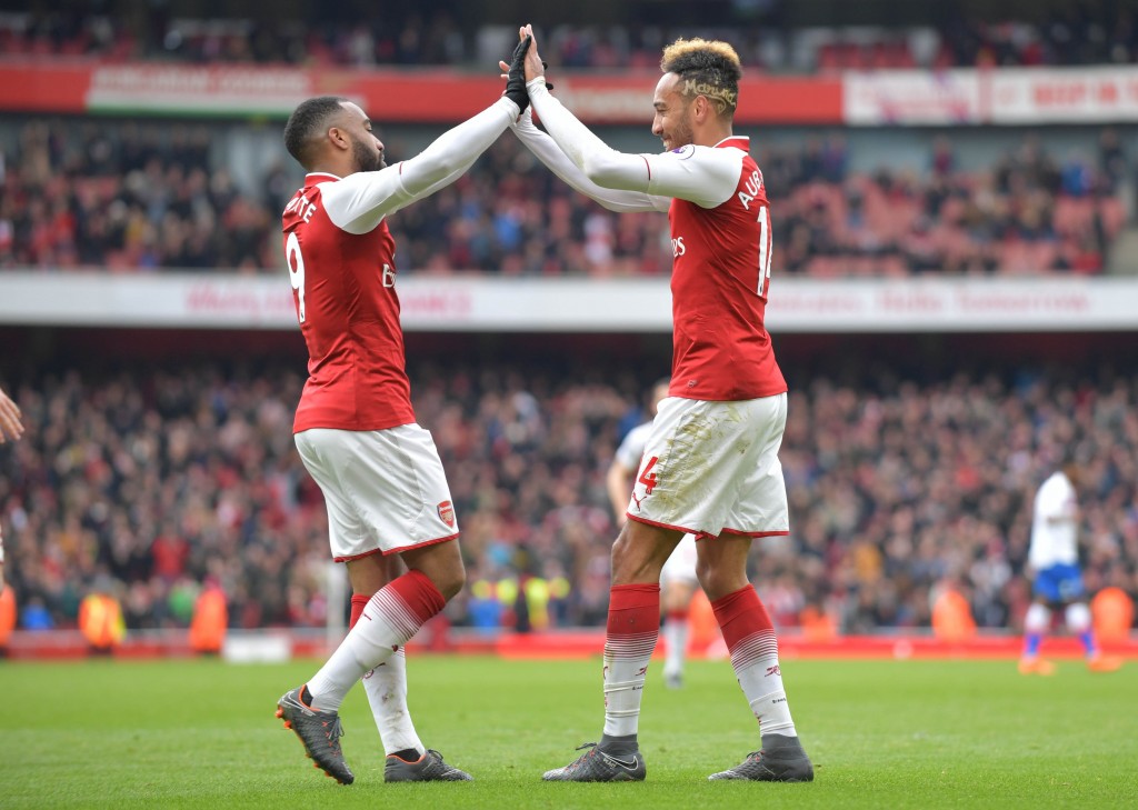 Arsenal's Gabonese striker Pierre-Emerick Aubameyang (R) celebrates scoring the team's second goal with Arsenal's French striker Alexandre Lacazette during the English Premier League football match between Arsenal and Stoke City at the Emirates Stadium in London on April 1, 2018. / AFP PHOTO / Oliver GREENWOOD / RESTRICTED TO EDITORIAL USE. No use with unauthorized audio, video, data, fixture lists, club/league logos or 'live' services. Online in-match use limited to 75 images, no video emulation. No use in betting, games or single club/league/player publications. / (Photo credit should read OLIVER GREENWOOD/AFP/Getty Images)