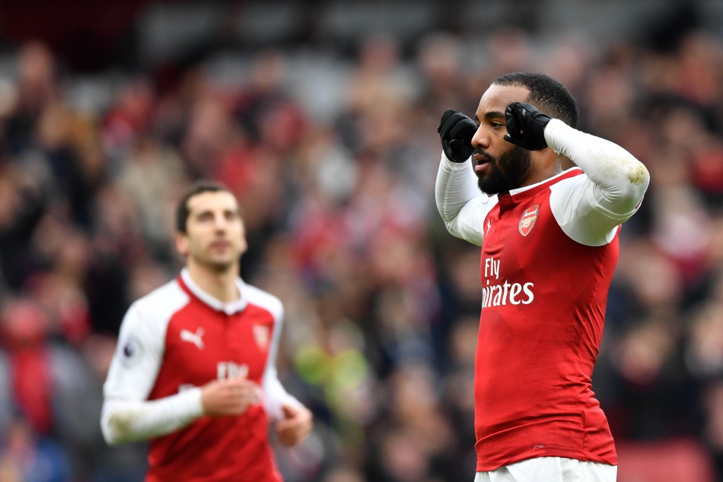 Arsenal's French striker Alexandre Lacazette (R) celebrates scoring the team's third goal during the English Premier League football match between Arsenal and Stoke City at the Emirates Stadium in London on April 1, 2018. / AFP PHOTO / Oliver GREENWOOD / RESTRICTED TO EDITORIAL USE. No use with unauthorized audio, video, data, fixture lists, club/league logos or 'live' services. Online in-match use limited to 75 images, no video emulation. No use in betting, games or single club/league/player publications. / (Photo credit should read OLIVER GREENWOOD/AFP/Getty Images)