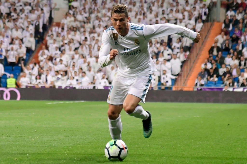 Real Madrid's Portuguese forward Cristiano Ronaldo runs with the ball during the Spanish league football match Real Madrid CF against Athletic Club Bilbao at the Santiago Bernabeu stadium in Madrid on April 18, 2018. / AFP PHOTO / JAVIER SORIANO (Photo credit should read JAVIER SORIANO/AFP/Getty Images)