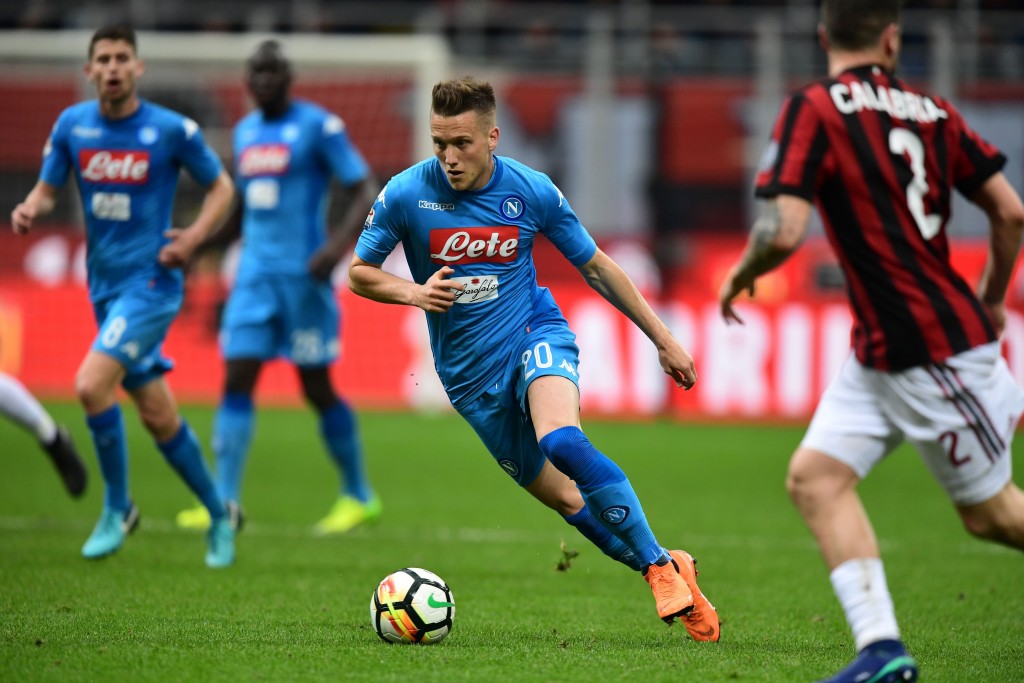 Napoli's Polish midfielder Piotr Zielinski runs the ball during the Italian Serie A football match between AC Milan and Napoli at San Siro stadium in Milan on April 15, 2018. / AFP PHOTO / MIGUEL MEDINA (Photo credit should read MIGUEL MEDINA/AFP/Getty Images)