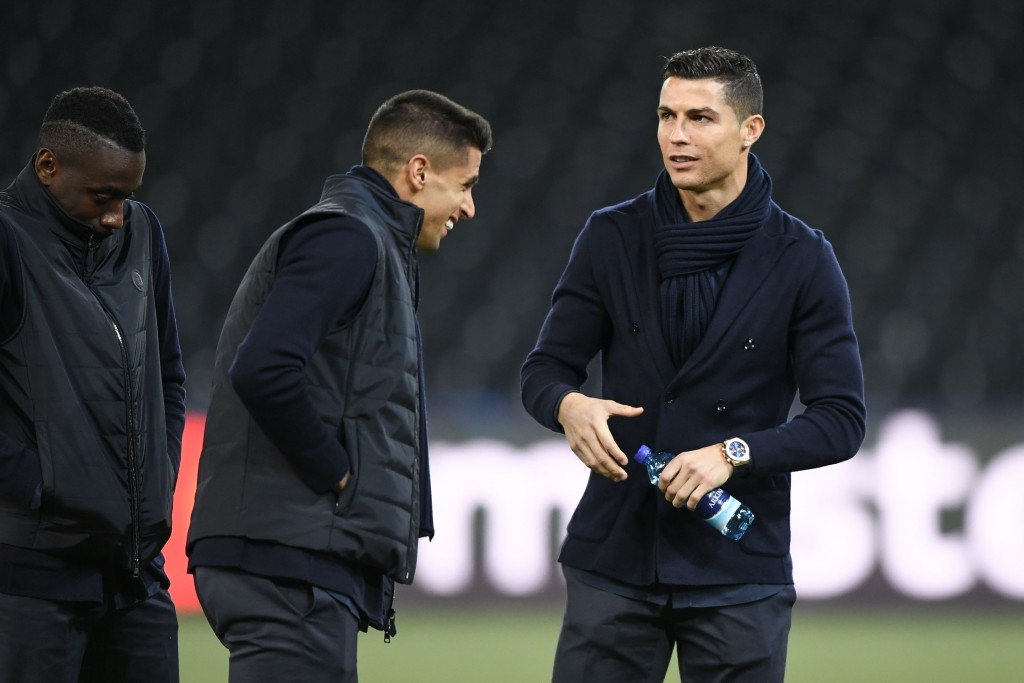 (From L) Juventus' French midfielder Blaise Matuidi, teammate Portuguese defender Joao Cancelo and teammate Portuguese forward Cristiano Ronaldo inspect the pitch ahead of the Champions League Group H football match between Young Boys and Juventus at the Stade de Suisse stadium on December 11, 2018 in Bern. (Photo by FABRICE COFFRINI / AFP) (Photo credit should read FABRICE COFFRINI/AFP/Getty Images)