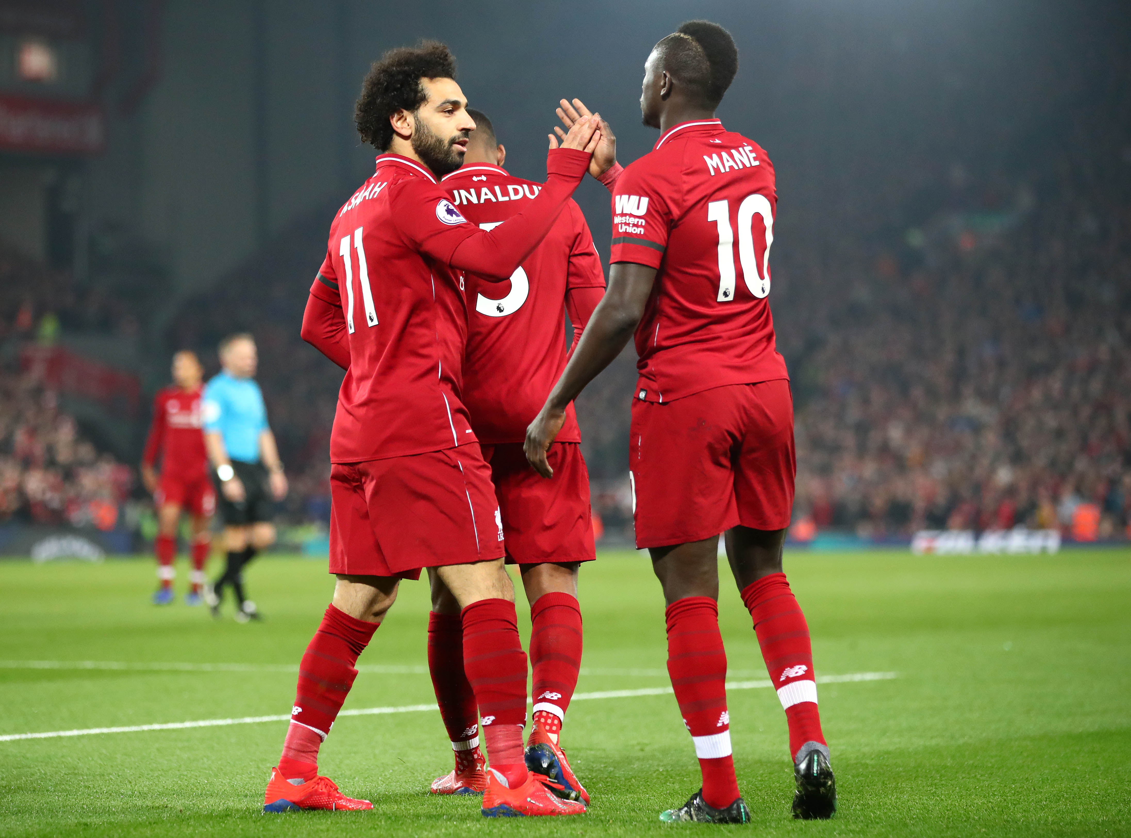 LIVERPOOL, ENGLAND - FEBRUARY 27: Sadio Mane of Liverpool celebrates after scoring his team's first goal with Mohamed Salah of Liverpool during the Premier League match between Liverpool FC and Watford FC at Anfield on February 27, 2019 in Liverpool, United Kingdom. (Photo by Clive Brunskill/Getty Images)