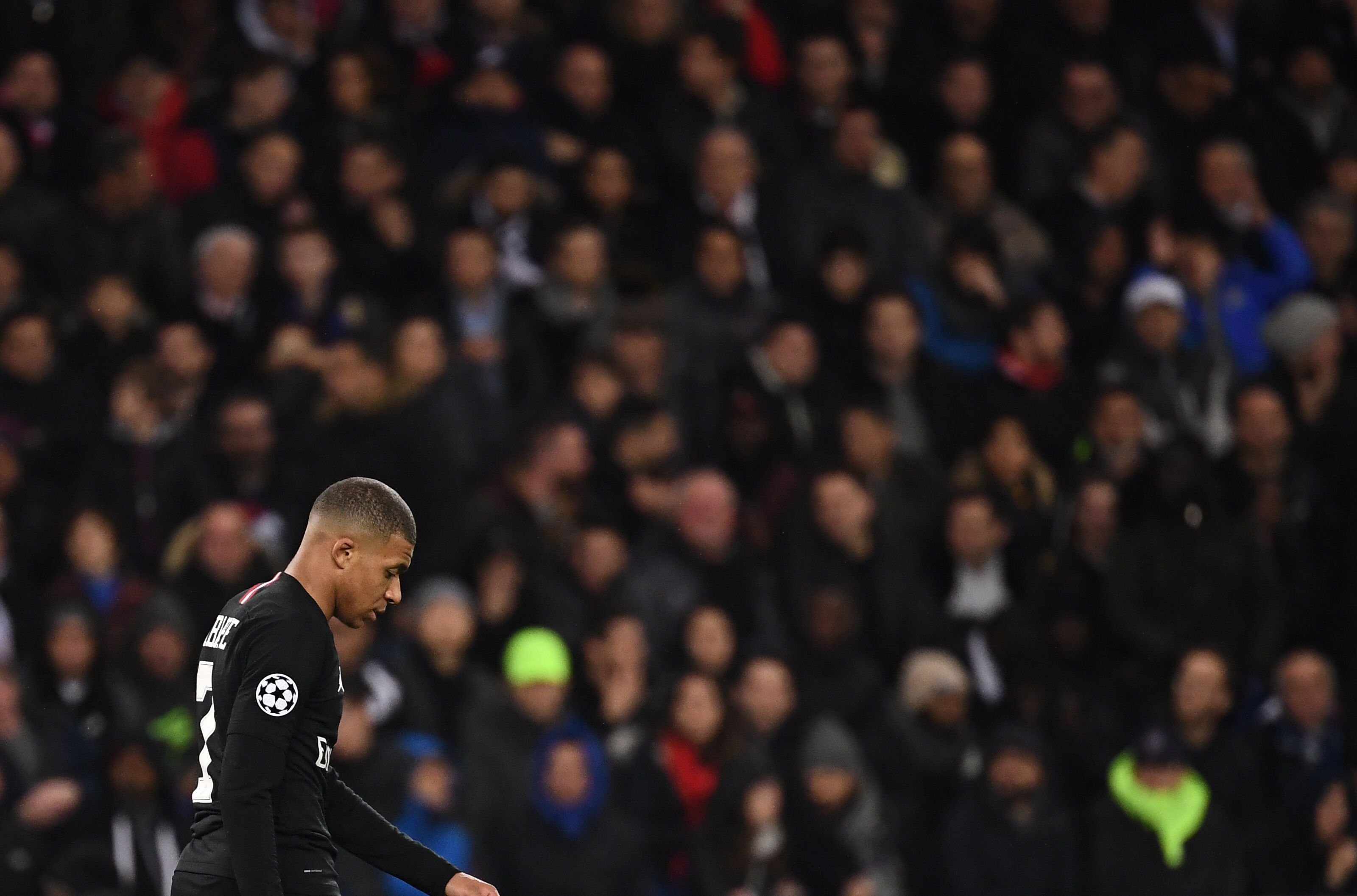 TOPSHOT - Paris Saint-Germain's French forward Kylian Mbappe (L) looks on during the UEFA Champions League round of 16 second-leg football match between Paris Saint-Germain (PSG) and Manchester United at the Parc des Princes stadium in Paris on March 6, 2019. (Photo by FRANCK FIFE / AFP) (Photo credit should read FRANCK FIFE/AFP/Getty Images)