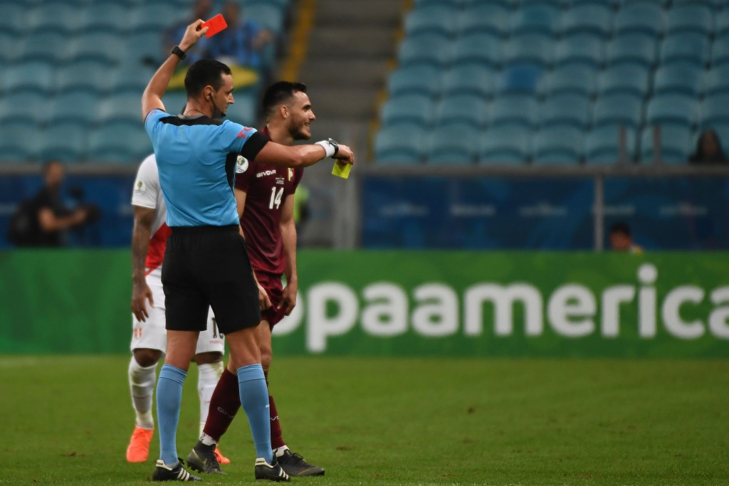 Colombian referee Wilmar Roldan awards a second yellow card to Venezuela's Luis Del Pino Mago as sends him off the pitch during the Copa America football tournament group match between Venezuela and Peru at the Gremio Arena in Porto Alegre, Brazil, on June 15, 2019. (Photo by EVARISTO SA / AFP) (Photo credit should read EVARISTO SA/AFP/Getty Images)