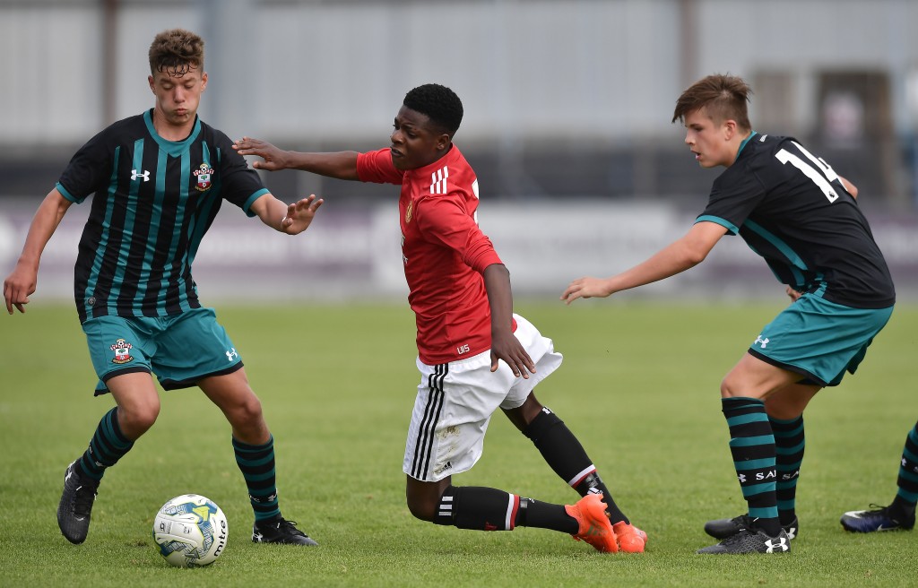 COLERAINE, NORTHERN IRELAND - JULY 26: Ademipo Odubeko (C) of Manchester United is fouled by Jack Turner (L) and Sam Bailey (R) of Southampton during the Super Cup NI tournament group game between Manchester United u16's and Southampton u16's at the Showgrounds on July 26, 2017 in Coleraine, Northern Ireland. (Photo by Charles McQuillan/Getty Images)