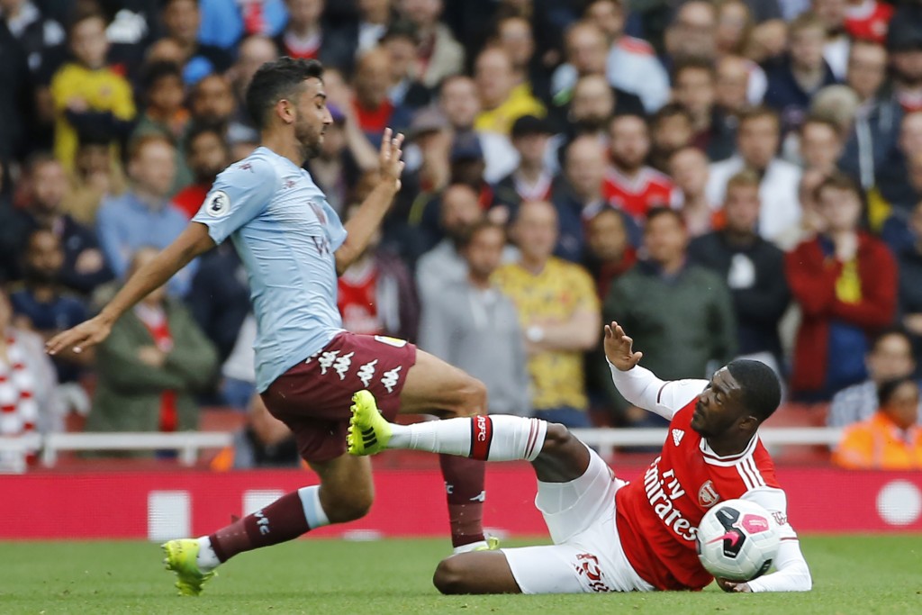 Maitland-Niles makes the tackle that earned him the red-card and let Arsenal down. (Photo by Tolga Akmen/AFP/Getty Images)