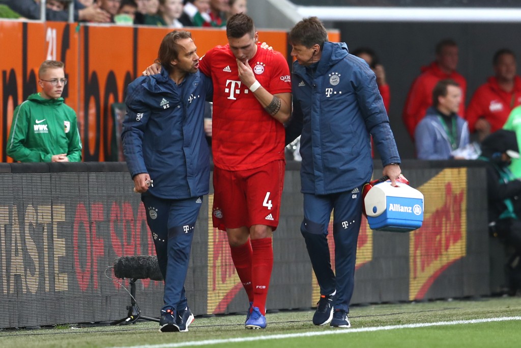 AUGSBURG, GERMANY - OCTOBER 19: Niklas Suele of FC Bayern Munich receives medical treatment during the Bundesliga match between FC Augsburg and FC Bayern Muenchen at WWK-Arena on October 19, 2019 in Augsburg, Germany. (Photo by Alexander Hassenstein/Bongarts/Getty Images)