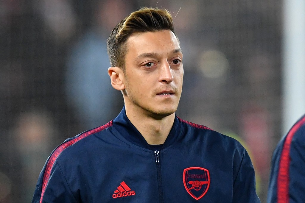 Arsenal's German midfielder Mesut Ozil reacts as he greets Liverpool players ahead of the English League Cup fourth round football match between Liverpool and Arsenal at Anfield in Liverpool, north west England on October 30, 2019. (Photo by Paul ELLIS / AFP) / RESTRICTED TO EDITORIAL USE. No use with unauthorized audio, video, data, fixture lists, club/league logos or 'live' services. Online in-match use limited to 75 images, no video emulation. No use in betting, games or single club/league/player publications. / (Photo by PAUL ELLIS/AFP via Getty Images)